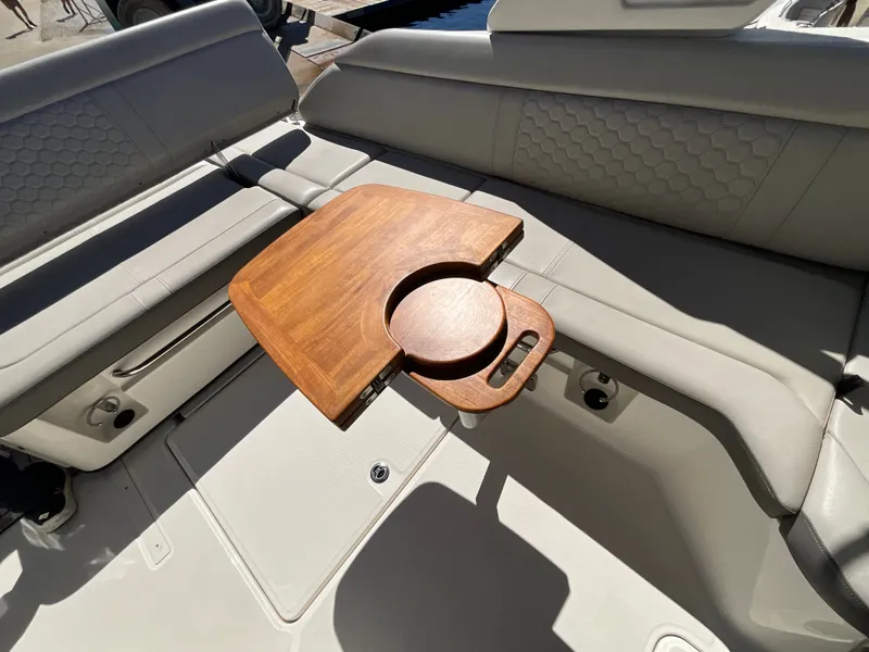 Slide: The Image of A sleek interior with gray upholstered seats and a wooden table in the center. - 13