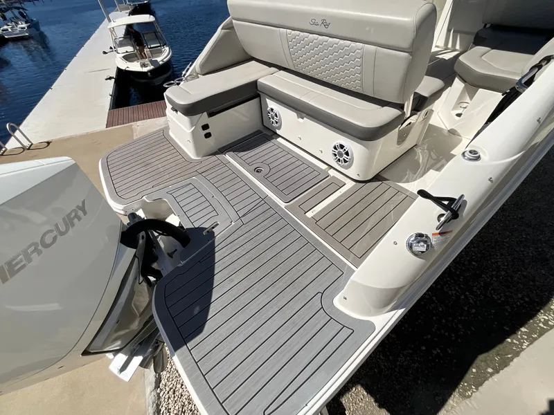 Slide: The Image of The image shows the stern of a 2021 Sea Ray SDX 250 Outboard with a gray deck. - 25