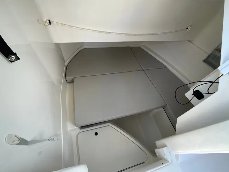 Slide: The Image of Interior of the 2021 Sea Ray SDX 250 Outboard with cushioned seating and storage space. - 3