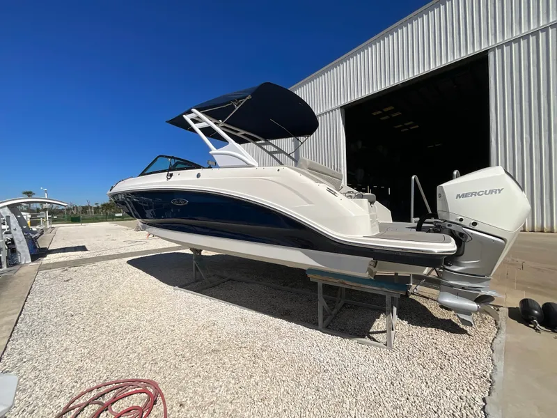 Slide: The Image of A 2021 Sea Ray SDX 250 Outboard is on a stand outside a storage facility. - 19