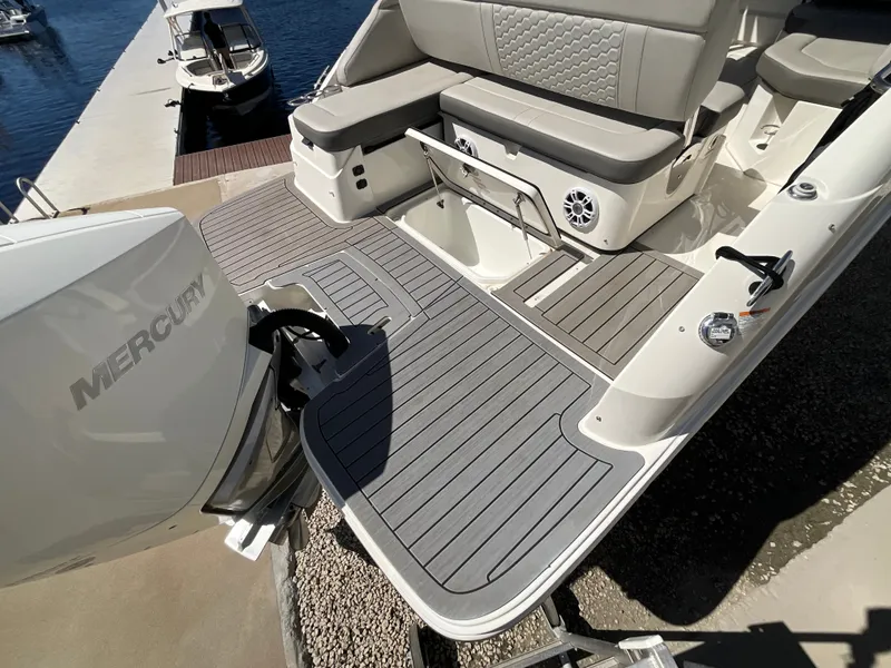 Slide: The Image of The image shows the stern of a 2021 Sea Ray SDX 250 Outboard with a gray deck. - 23
