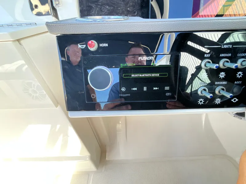 Slide: The Image of The image shows the dashboard of a Sea Ray SDX 250 Outboard with a Fusion Bluetooth system. - 9