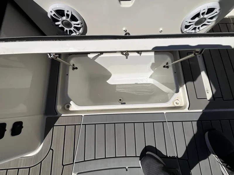 Slide: The Image of An open storage compartment on a 2021 Sea Ray SDX 250 Outboard boat. - 24