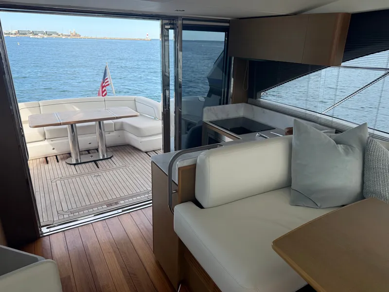 Slide: The Image of Interior of a luxury yacht with sea view, wooden floors, and elegant seating. - 44
