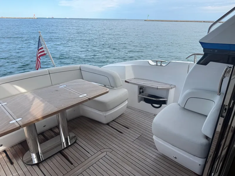Slide: The Image of The 2023 Princess F45 features an elegant aft deck with white seating and a wooden table. - 11