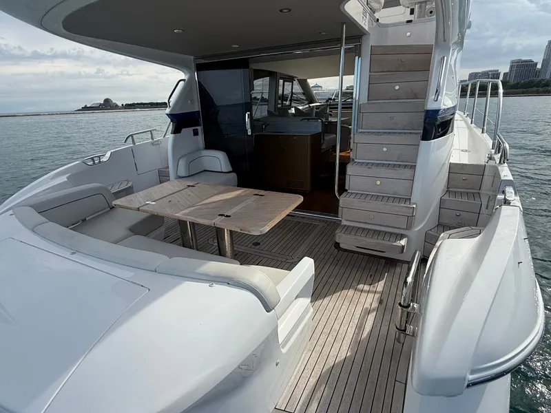 Slide: The Image of The 2023 Princess F45 features a sleek aft deck with seating area and table. - 8