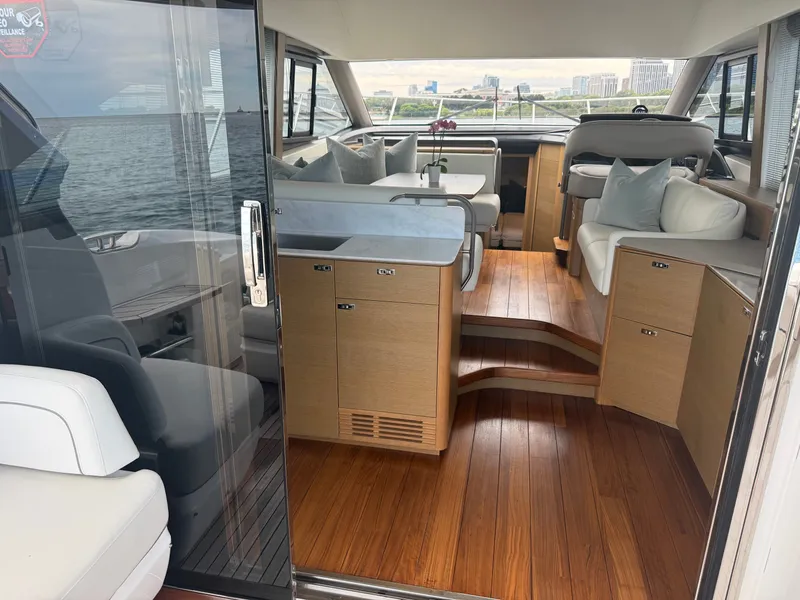 Slide: The Image of Interior view of a luxury yacht with wooden flooring, modern furnishings, and large windows. - 42