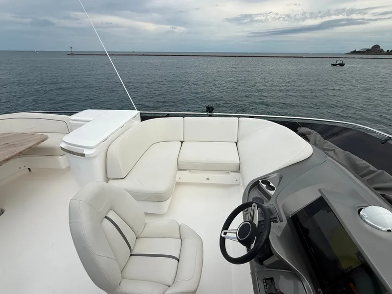 Slide: The Image of The image shows the deck of a 2023 Princess F45 yacht with white seating and a steering wheel. - 33