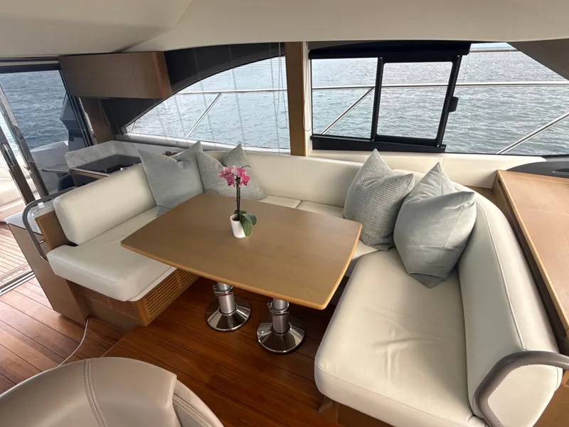 Slide: The Image of Interior of a luxury yacht with a sleek dining table and comfortable seating. - 48