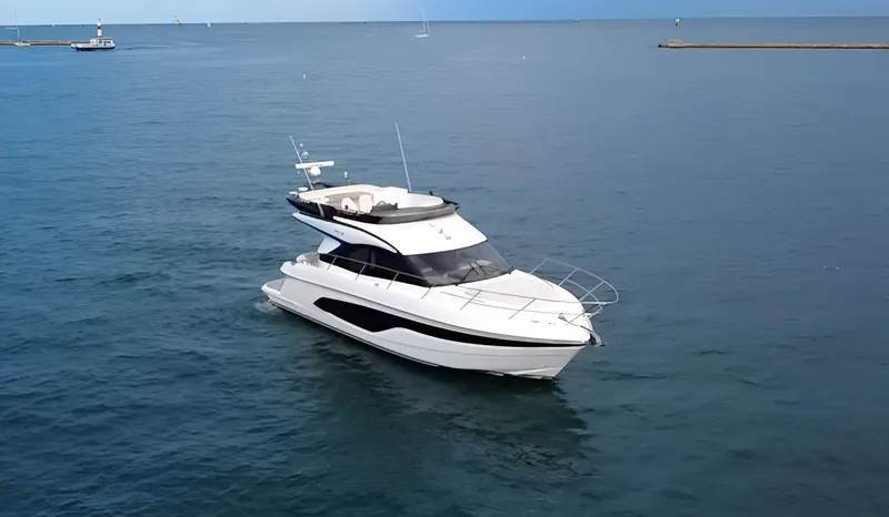 Slide: The Image of The 2023 Princess F45 is a sleek motor yacht on calm waters, featuring a modern design. - 1