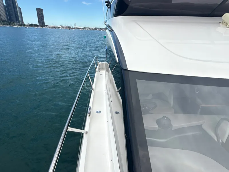 Slide: The Image of The 2023 Princess F45 cruising on calm waters with a city skyline in the background. - 23