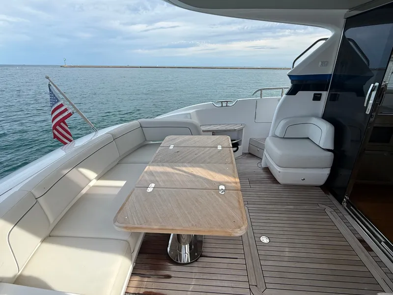 Slide: The Image of The image shows the aft deck of a Princess F45 yacht with a sleek seating area and table. - 9