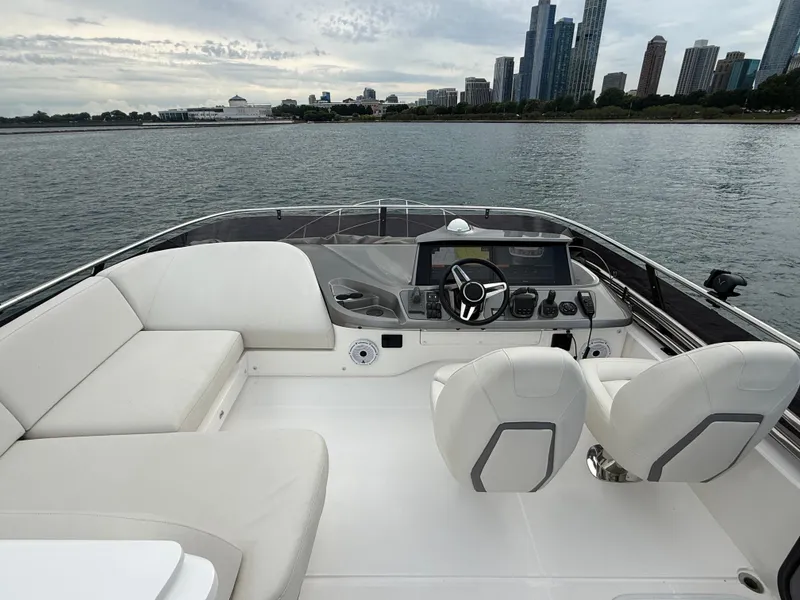 Slide: The Image of The image shows the cockpit of a 2023 Princess F45 yacht with modern seating and controls. - 36