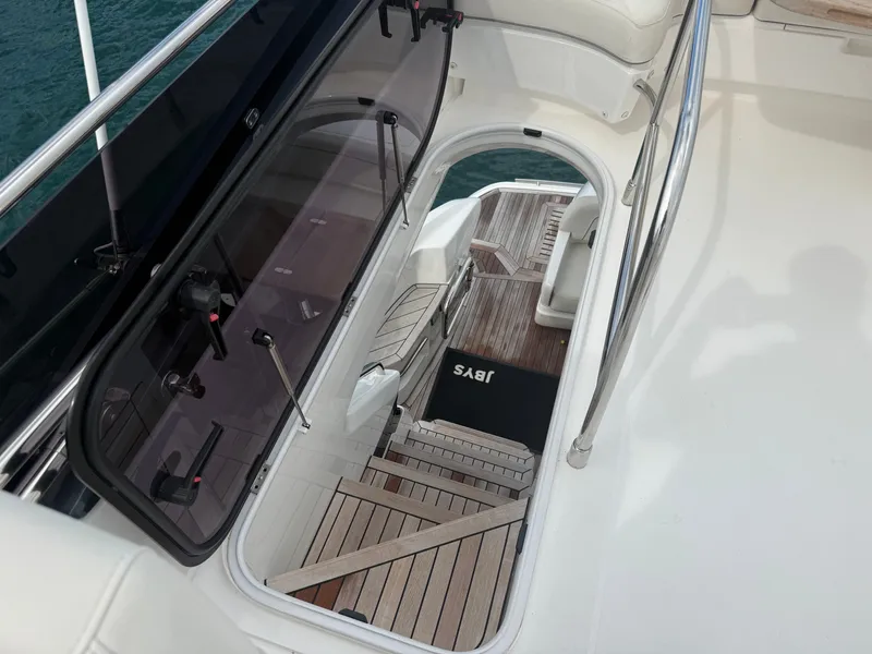 Slide: The Image of The 2023 Princess F45 features an elegant staircase with wooden flooring leading to a lower deck. - 26