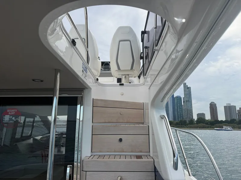 Slide: The Image of The stairs on the Princess F45 lead to the upper deck with a view of the skyline. - 25