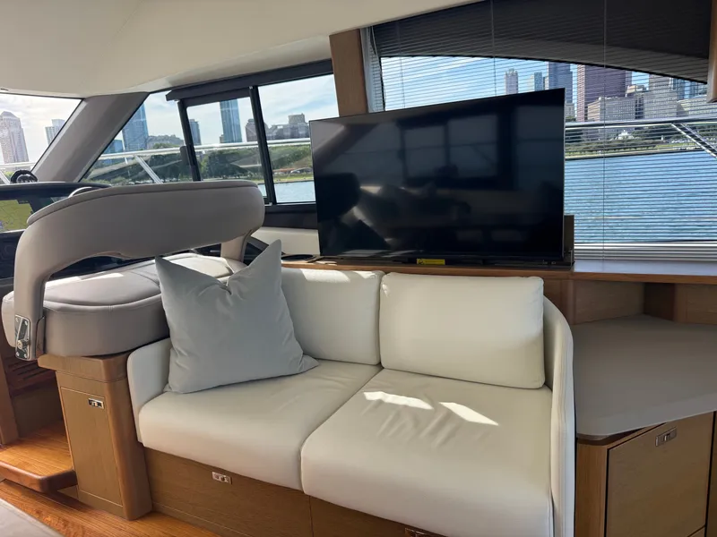 Slide: The Image of Interior of a modern yacht with a sofa, TV, and large windows offering a city view. - 47