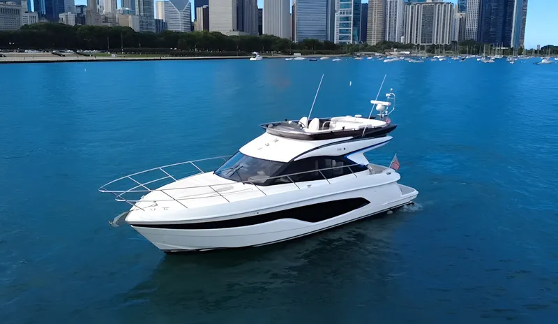 Slide: The Image of The 2023 Princess F45 cruises on calm waters with a city skyline in the background. - 0