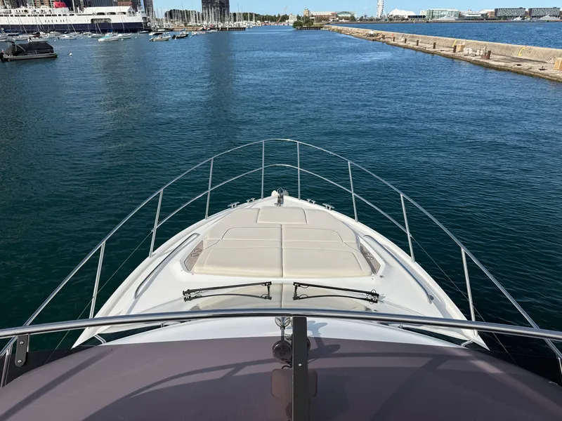 Slide: The Image of The image shows the bow of a luxury yacht docked in a harbor. - 38