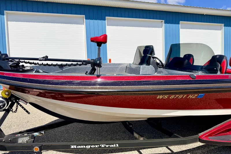 Slide: The Image of 2009 Ranger 620VS Fisherman boat on trailer, parked near blue building. - 18
