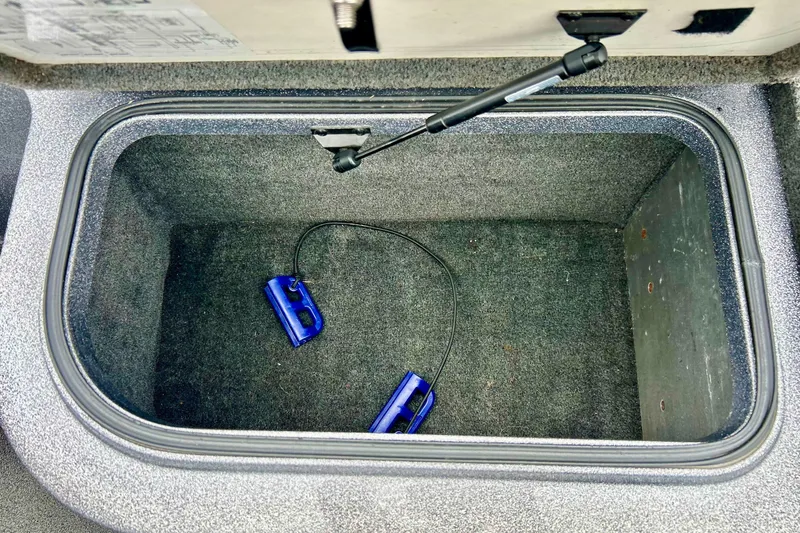 Slide: The Image of Storage compartment of a 2009 Ranger 620VS Fisherman boat with blue accessories inside. - 42