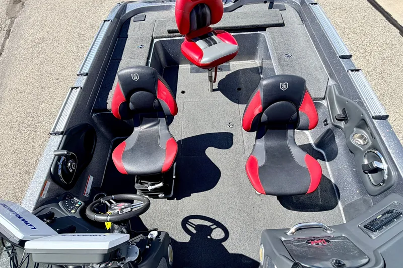 Slide: The Image of 2009 Ranger 620VS Fisherman boat interior with red and black seats, steering wheel, and controls. - 69