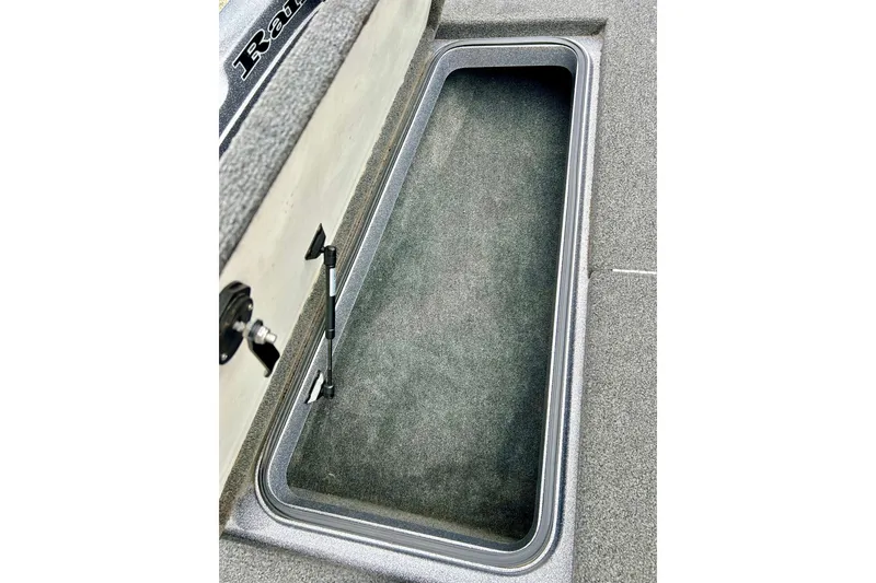 Slide: The Image of Storage compartment of 2009 Ranger 620VS Fisherman boat, featuring carpeted interior and secure latch. - 56