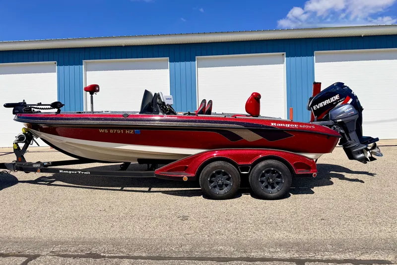 Slide: The Image of 2009 Ranger 620VS Fisherman boat with Evinrude motor, parked on trailer. - 3