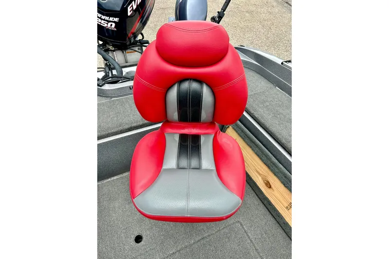 Slide: The Image of Red and gray seat on 2009 Ranger 620VS Fisherman boat, with Evinrude motor in background. - 27