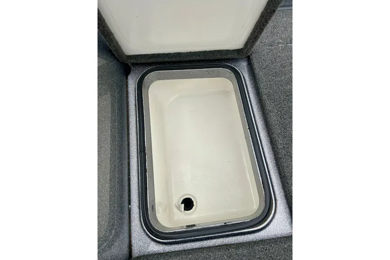 Slide: The Image of Open storage compartment in 2009 Ranger 620VS Fisherman boat, featuring a clean interior. - 55