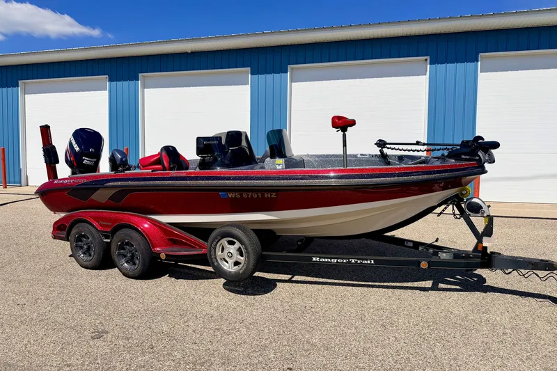 Slide: The Image of 2009 Ranger 620VS Fisherman boat on trailer, parked outside blue building. - 4