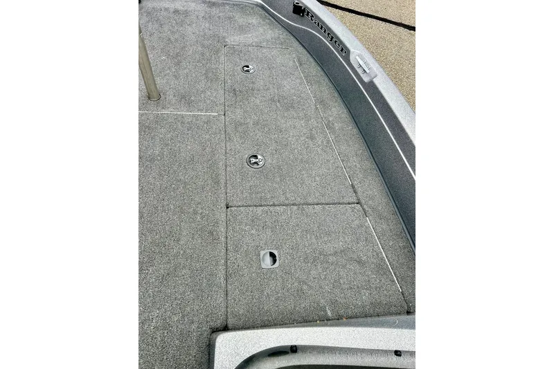 Slide: The Image of 2009 Ranger 620VS Fisherman boat deck with storage compartments and carpeted surface. - 51
