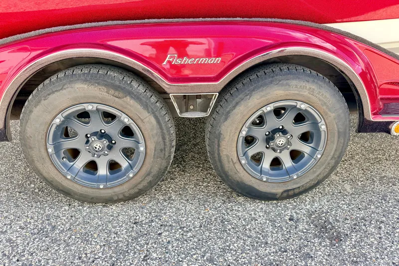 Slide: The Image of Red 2009 Ranger 620VS Fisherman trailer with dual black alloy wheels on asphalt. - 80