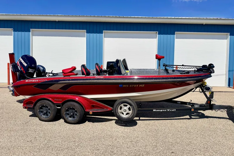 The Image of 2009 Ranger 620VS Fisherman boat on trailer, parked outside blue building. - 0