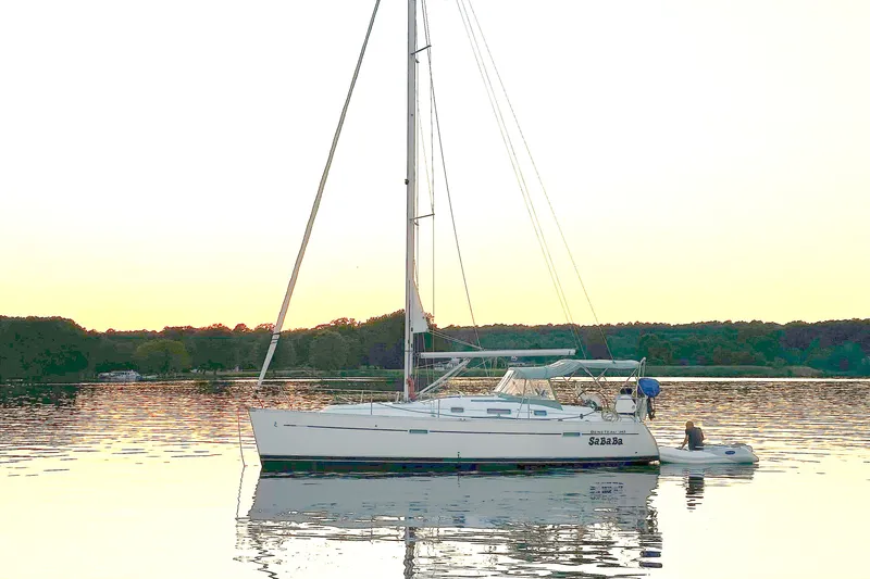 The Image of Sailboat Beneteau 343, 2009 model, anchored on calm water at sunset. - 1