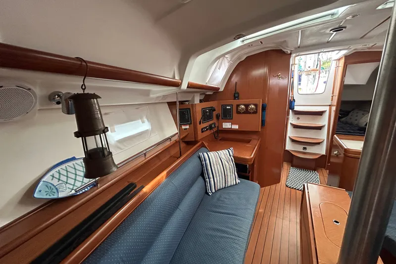 Slide: The Image of Interior of 2009 Beneteau 343 sailboat with cozy seating and wooden finishes. - 17