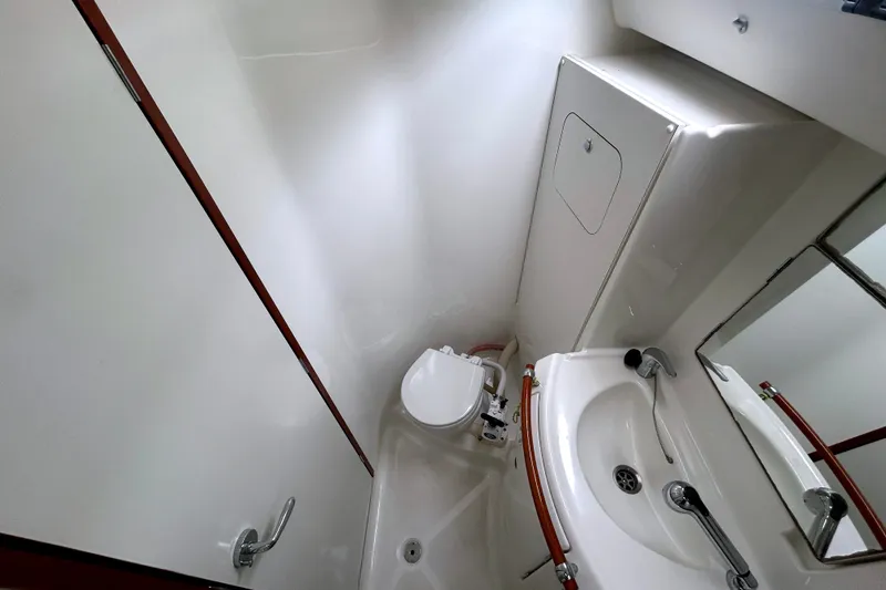 Slide: The Image of Compact bathroom in 2009 Beneteau 343 sailboat with toilet, sink, and mirror. - 31