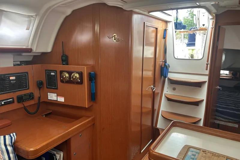 Slide: The Image of Interior of 2009 Beneteau 343 sailboat with navigation station and wooden cabinetry. - 22