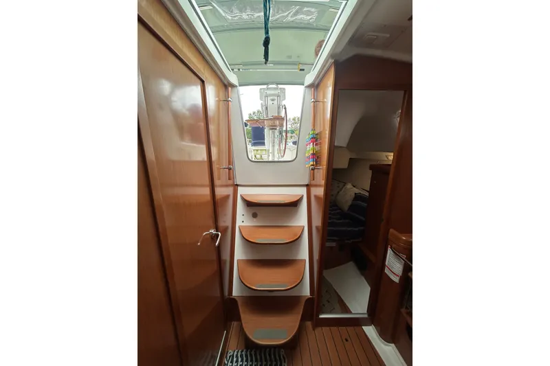 Slide: The Image of Interior view of 2009 Beneteau 343 sailboat with wooden steps and cozy cabin. - 27