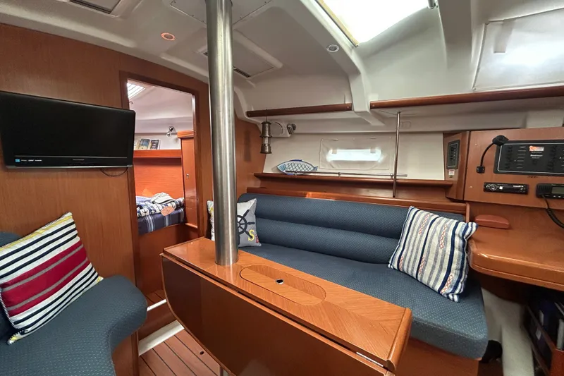 Slide: The Image of Interior of 2009 Beneteau 343 sailboat with cozy seating and modern amenities. - 16