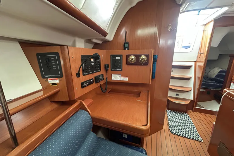 Slide: The Image of Interior of a 2009 Beneteau 343 sailboat with navigation station and wooden finish. - 20