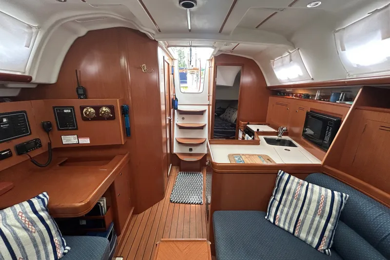 Slide: The Image of Interior of a 2009 Beneteau 343 sailboat with wood finish and modern amenities. - 19