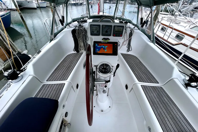 Slide: The Image of Cockpit of 2009 Beneteau 343 sailboat with navigation equipment and steering wheel. - 13