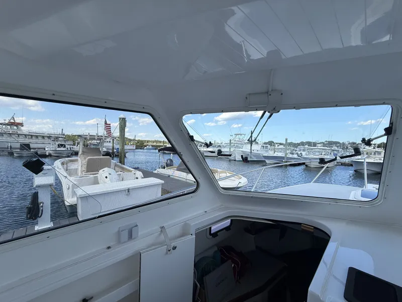 Slide: The Image of The image shows the interior of a 2020 NorthCoast 285 HT with a view of a marina. - 17