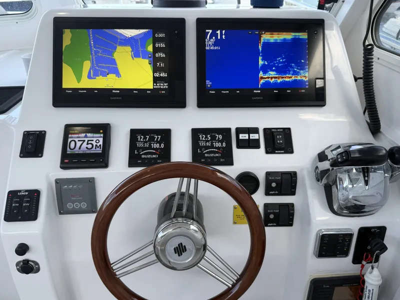 Slide: The Image of The image shows the helm of a 2020 NorthCoast 285 HT boat with modern navigation systems. - 20