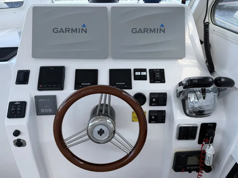 Slide: The Image of The image shows the helm of a 2020 NorthCoast 285 HT boat with Garmin screens. - 19