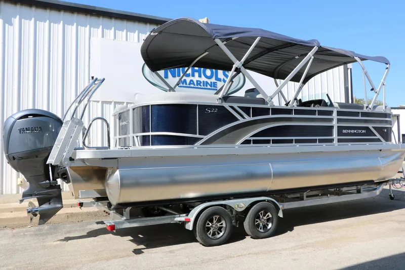 Slide: The Image of Bennington 22 SSR Tri Toon 2027 on a trailer, featuring a sunshade and Yamaha engine. - 14