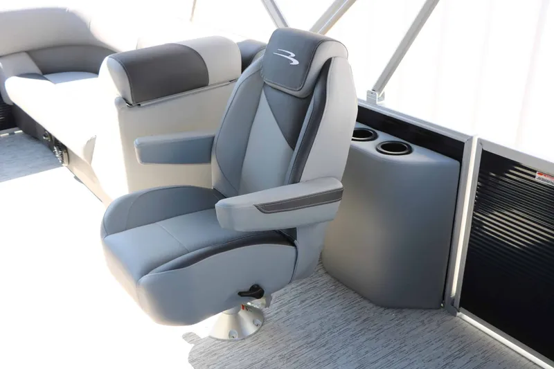 Slide: The Image of Interior of a 2027 Bennington 22 SSR Tri Toon featuring a cushioned captain's chair. - 34