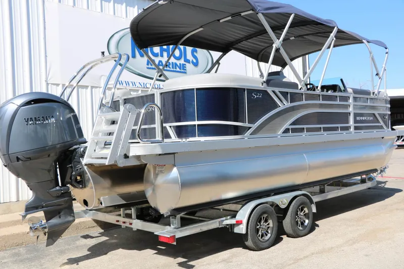 Slide: The Image of Bennington 22 SSR Tri Toon 2027 with Yamaha outboard motor, on a trailer in front of a building. - 15