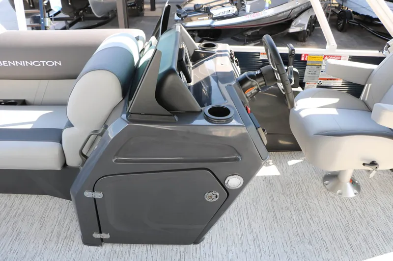 Slide: The Image of The image shows the cockpit of a 2027 Bennington 22 SSR Tri Toon with a gray dashboard and comfortable seating. - 36