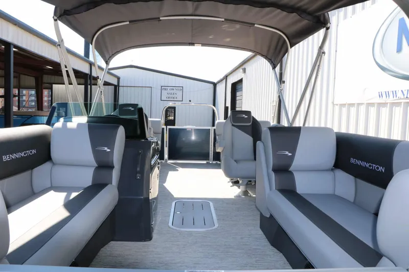 Slide: The Image of Interior of a Bennington 22 SSR Tri Toon with gray seating and a canopy. - 28